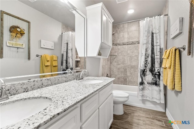 full bathroom with vanity, toilet, and shower / bath combo with shower curtain