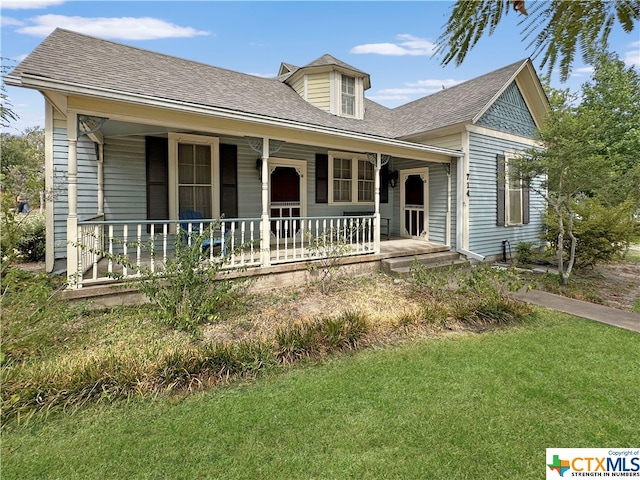 view of front of house with a front yard and covered porch