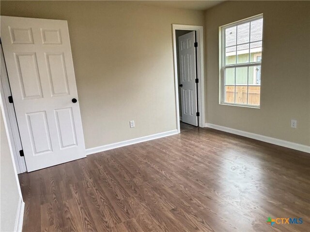 710 E 5th St, Nixon, TX 78140 - unfurnished room with dark wood-type flooring and baseboards