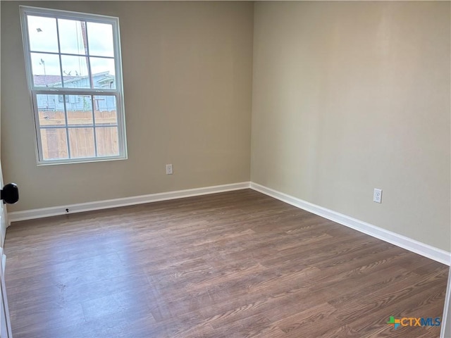 710 E 5th St, Nixon, TX 78140 - unfurnished room featuring dark wood finished floors and baseboards