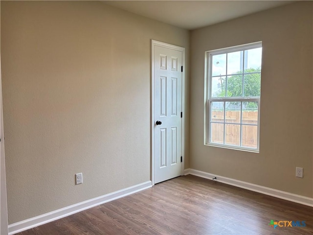 710 E 5th St, Nixon, TX 78140 - empty room with dark wood finished floors and baseboards