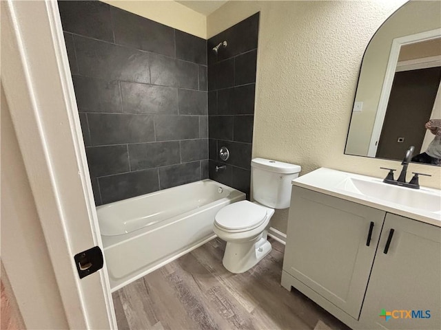 710 E 5th St, Nixon, TX 78140 - full bathroom with wood finished floors, a textured wall, vanity, and shower / bath combination