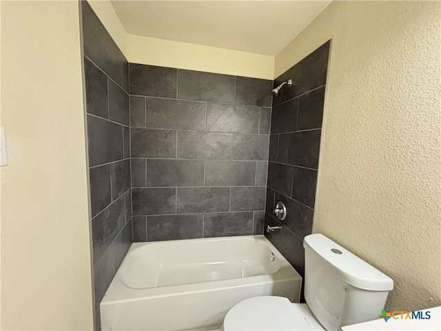 710 E 5th St, Nixon, TX 78140 - bathroom featuring a textured wall and shower / bath combination