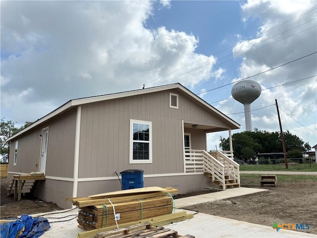 710 E 5th St, Nixon, TX 78140 - view of side of property featuring a jacuzzi, covered porch, and stairs