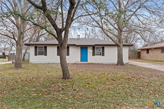 ranch-style home featuring fence and a front yard