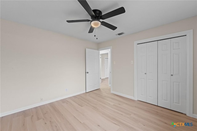 unfurnished bedroom featuring ceiling fan, a closet, and light hardwood / wood-style floors