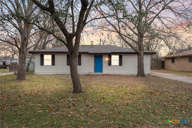 single story home with fence and a lawn