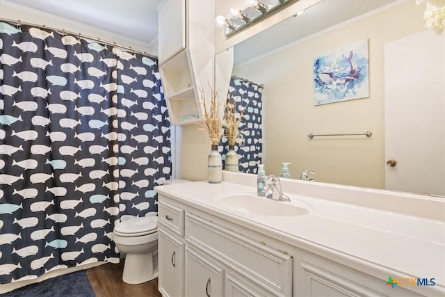 bathroom with hardwood / wood-style floors, vanity, toilet, and ornamental molding