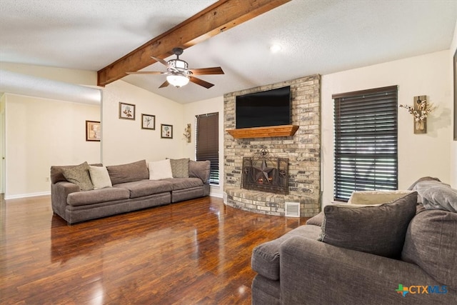 living room featuring lofted ceiling with beams, dark hardwood / wood-style floors, a textured ceiling, and ceiling fan