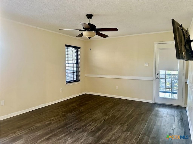 spare room with crown molding, ceiling fan, dark wood-type flooring, and a textured ceiling