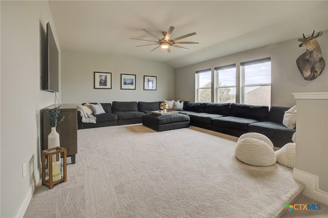 living room featuring ceiling fan, lofted ceiling, and carpet flooring