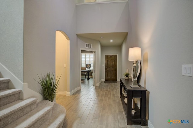 foyer entrance with a towering ceiling