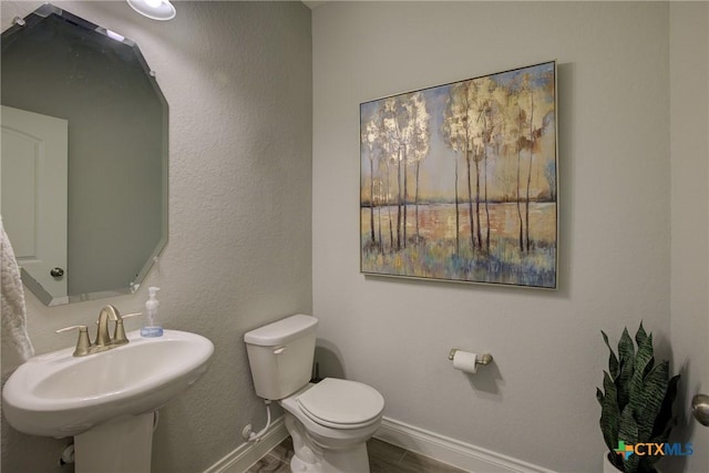 bathroom featuring sink and toilet