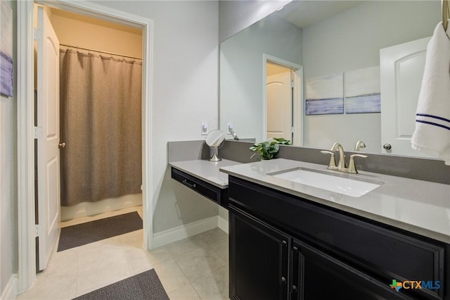 bathroom with vanity, curtained shower, and tile patterned floors