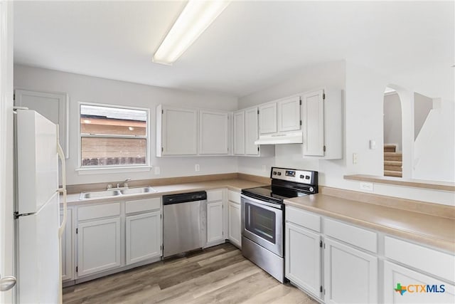 9538 Beau Brg, San Antonio, TX 78254 - kitchen featuring stainless steel appliances, under cabinet range hood, light wood finished floors, and white cabinetry