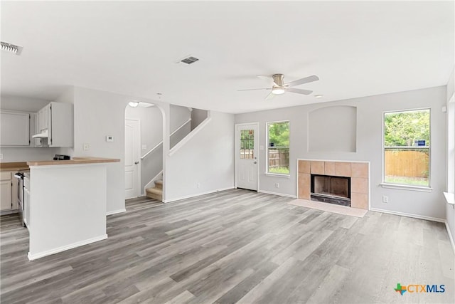 9538 Beau Brg, San Antonio, TX 78254 - unfurnished living room with a ceiling fan, healthy amount of natural light, light wood finished floors, and stairs