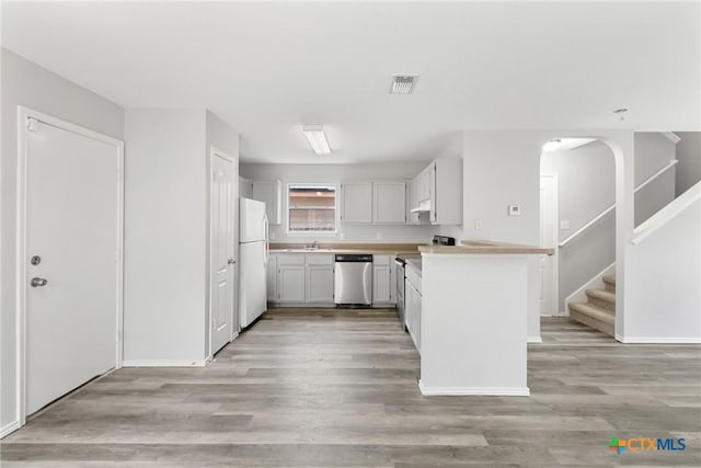 9538 Beau Brg, San Antonio, TX 78254 - kitchen with dishwasher, freestanding refrigerator, light countertops, under cabinet range hood, and light wood-style flooring