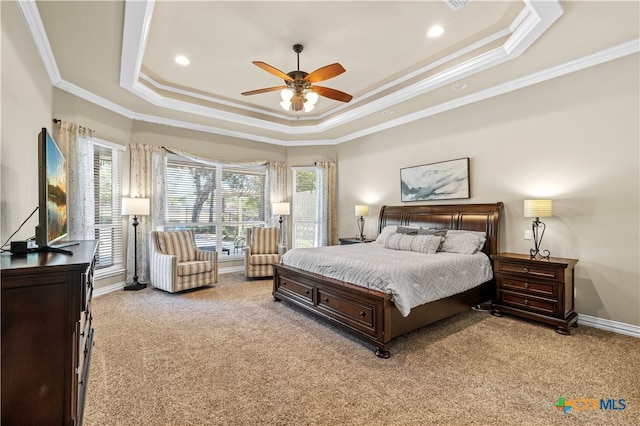 bedroom featuring a tray ceiling, light carpet, ceiling fan, and crown molding