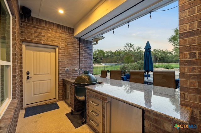 patio terrace at dusk with area for grilling