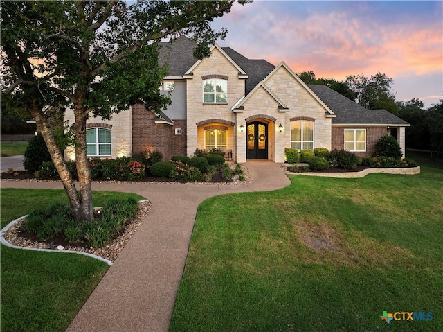 1710 Las Lomas Ct, Temple, TX 76502 - french provincial home featuring french doors, stone siding, a front lawn, and roof with shingles