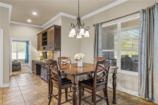 dining space with light tile patterned flooring, crown molding, and a notable chandelier