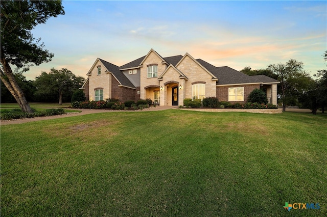 french provincial home featuring a yard