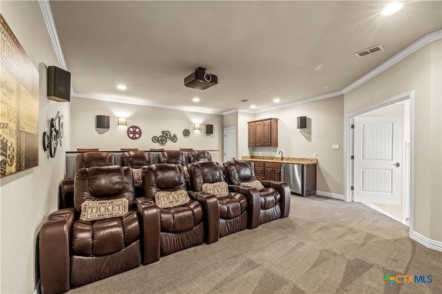 cinema featuring ornamental molding, light colored carpet, and indoor bar