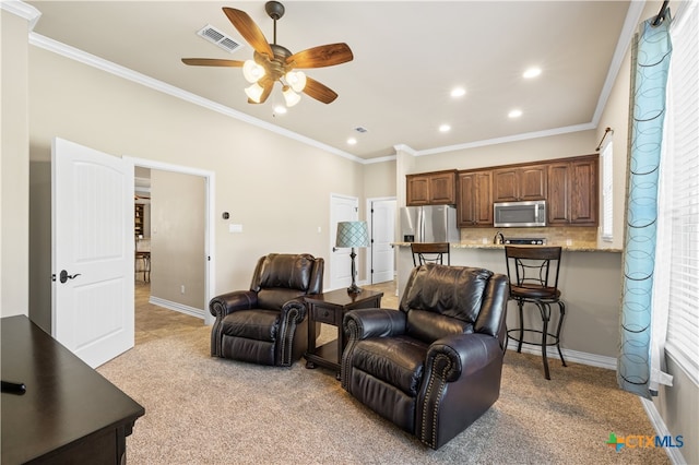 carpeted living room with ceiling fan, plenty of natural light, and crown molding