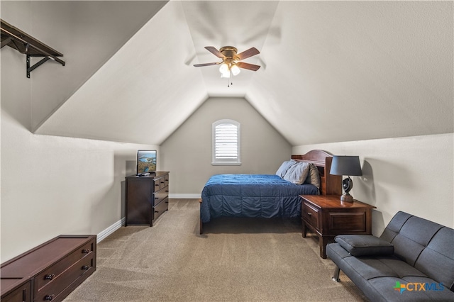 bedroom featuring vaulted ceiling, light colored carpet, and ceiling fan