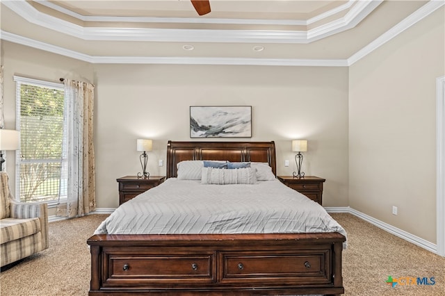 bedroom featuring ceiling fan, a tray ceiling, carpet, and ornamental molding