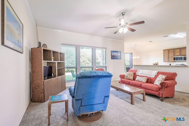 5821 Worthing Dr, Temple, TX 76502 - carpeted living room with ceiling fan, crown molding, and a chandelier