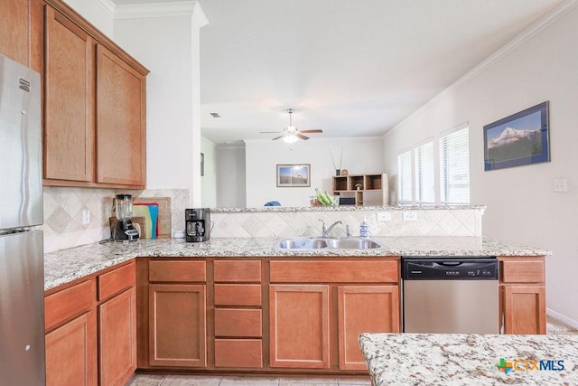 5821 Worthing Dr, Temple, TX 76502 - kitchen with appliances with stainless steel finishes, tasteful backsplash, a ceiling fan, crown molding, and light stone countertops