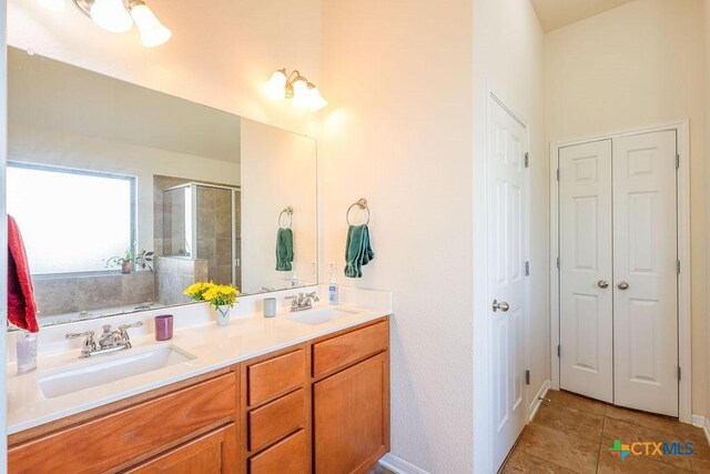 5821 Worthing Dr, Temple, TX 76502 - full bathroom featuring a stall shower, double vanity, tile patterned floors, and a closet