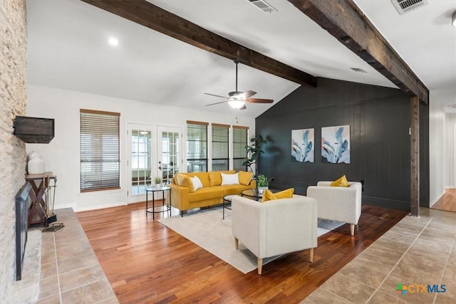 living room with french doors, visible vents, vaulted ceiling with beams, and wood finished floors