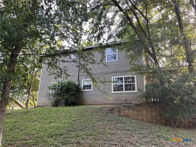 114 N Andrews Dr, Robinson, TX 76706 - back of house featuring central AC unit and a yard