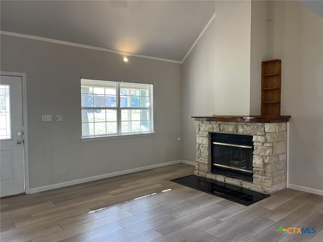 114 N Andrews Dr, Robinson, TX 76706 - unfurnished living room featuring crown molding, a stone fireplace, wood finished floors, baseboards, and lofted ceiling