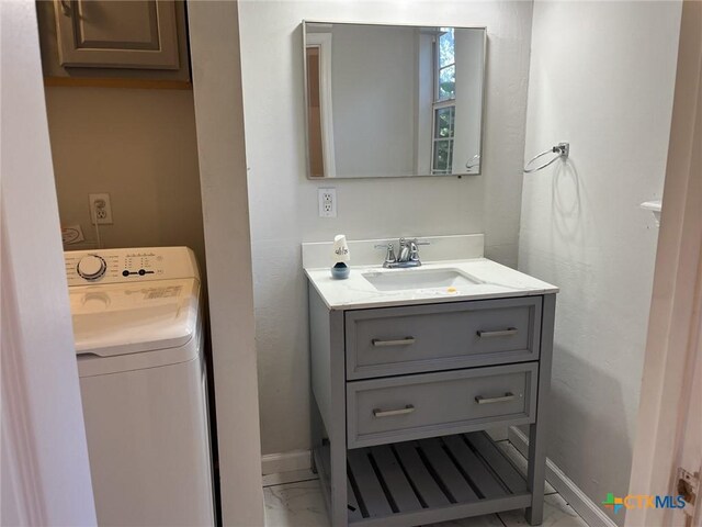114 N Andrews Dr, Robinson, TX 76706 - bathroom with washer / dryer, vanity, marble finish floor, and baseboards