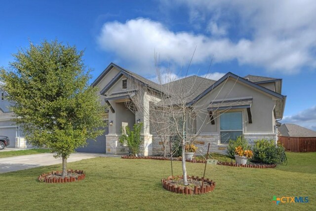 view of front facade with a garage and a front yard