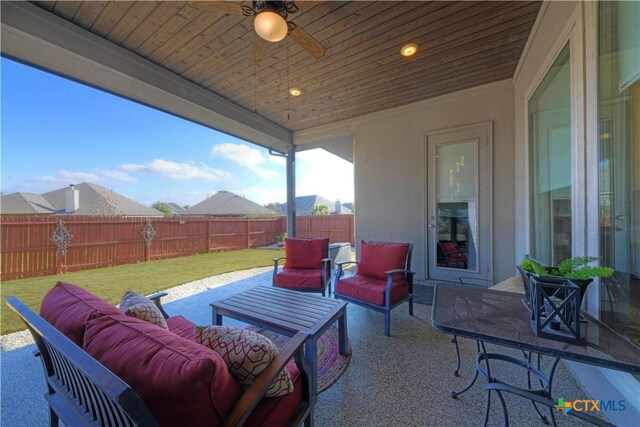 view of patio with outdoor lounge area and ceiling fan