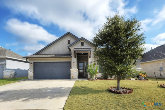 view of front of home featuring a garage and a front yard