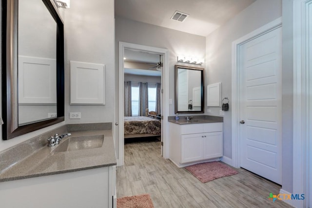 bathroom with vanity and hardwood / wood-style floors