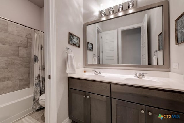 full bathroom featuring vanity, toilet, and shower / bath combo with shower curtain