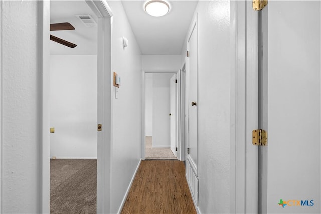 hallway with dark hardwood / wood-style flooring