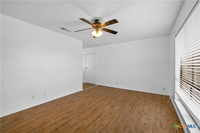 empty room featuring ceiling fan and hardwood / wood-style floors