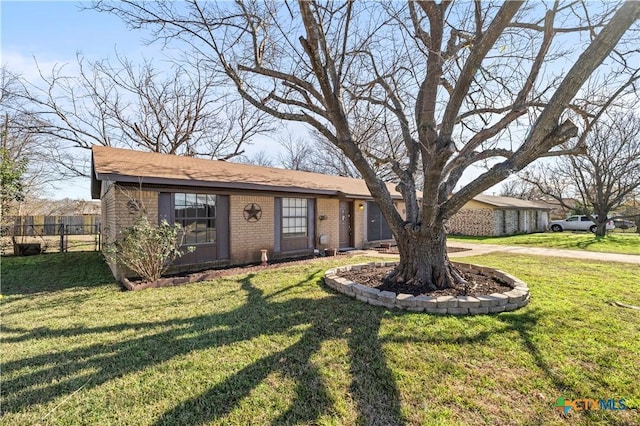 ranch-style home with a front lawn