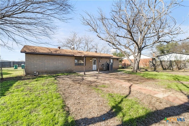 rear view of house with a yard and a patio