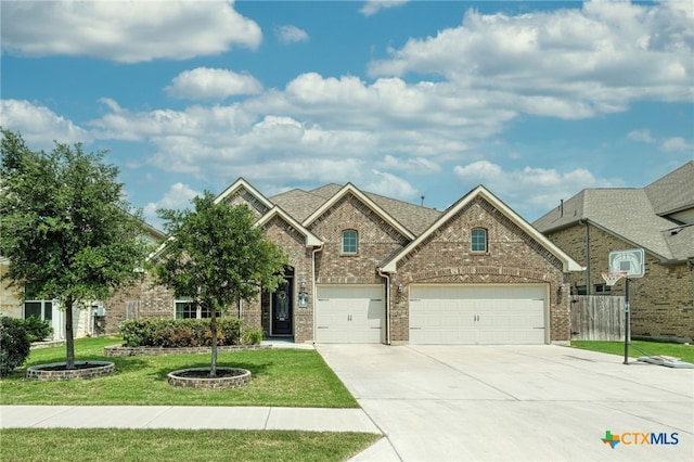 19500 Chayton Cir, Pflugerville, TX 78660 - view of front of property featuring driveway, a front yard, and brick siding