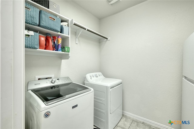 19500 Chayton Cir, Pflugerville, TX 78660 - laundry area with independent washer and dryer, light tile patterned floors, and baseboards