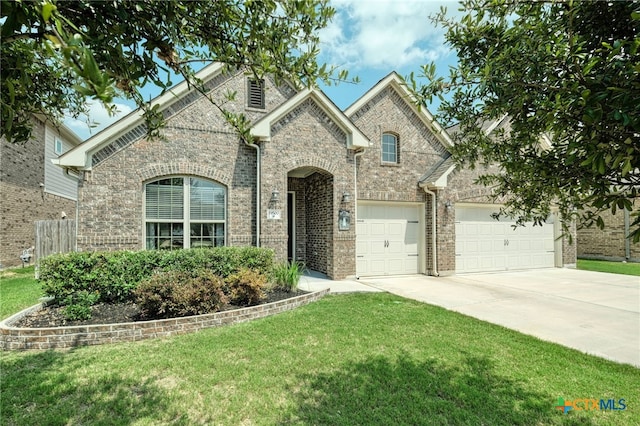 19500 Chayton Cir, Pflugerville, TX 78660 - french country style house with concrete driveway, a front lawn, and brick siding