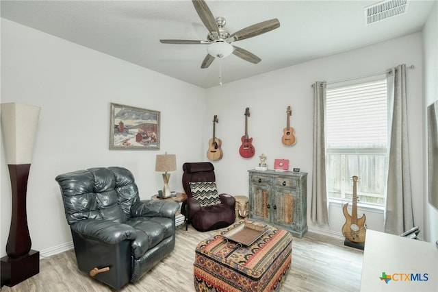 19500 Chayton Cir, Pflugerville, TX 78660 - living area featuring wood finished floors, baseboards, healthy amount of natural light, and a ceiling fan